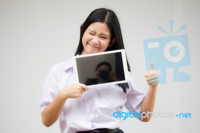 Portrait Of Thai High School Student Uniform Beautiful Girl Using Her Tablet Stock Photo