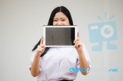 Portrait Of Thai High School Student Uniform Beautiful Girl Using Her Tablet Stock Photo