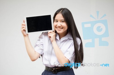 Portrait Of Thai High School Student Uniform Beautiful Girl Using Her Tablet Stock Photo