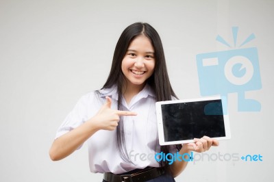 Portrait Of Thai High School Student Uniform Beautiful Girl Using Her Tablet Stock Photo