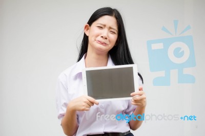 Portrait Of Thai High School Student Uniform Beautiful Girl Using Her Tablet Stock Photo