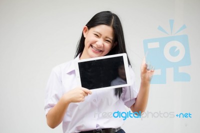 Portrait Of Thai High School Student Uniform Beautiful Girl Using Her Tablet Stock Photo