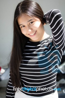 Portrait Of Thai Student Teen Beautiful Girl Relax And Smile Stock Photo