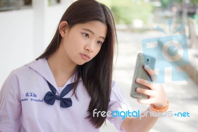 Portrait Of Thai Student Teen Beautiful Girl Using Her Smart Phone Selfie In School Stock Photo