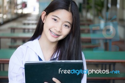 Portrait Of Thai Student Teen Beautiful Girl Using Her Tablet Stock Photo