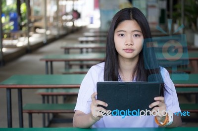 Portrait Of Thai Student Teen Beautiful Girl Using Her Tablet Stock Photo