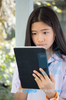 Portrait Of Thai Student Teen Beautiful Girl Using Her Tablet Stock Photo