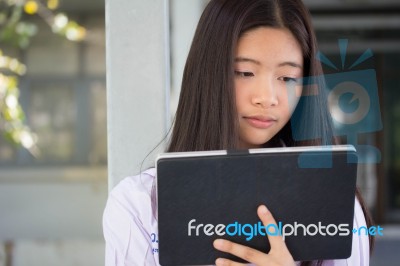 Portrait Of Thai Student Teen Beautiful Girl Using Her Tablet Stock Photo