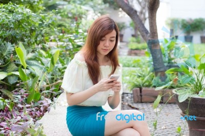 Portrait Of Thai Student University Beautiful Girl Using Her Smart Phone Stock Photo