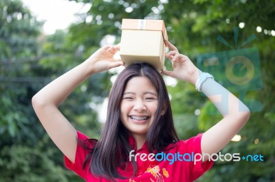 Portrait Of Thai Teen Beautiful Girl In Chinese Dress, Happy New Year And Open Box Gift, Smile And Very Happy Stock Photo