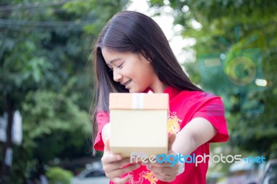 Portrait Of Thai Teen Beautiful Girl In Chinese Dress, Happy New Year And Open Box Gift, Smile And Very Happy Stock Photo