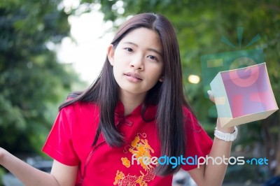 Portrait Of Thai Teen Beautiful Girl In Chinese Dress, Happy New Year And Open Box Gift, Smile And Very Happy Stock Photo