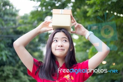 Portrait Of Thai Teen Beautiful Girl In Chinese Dress, Happy New Year And Open Box Gift, Smile And Very Happy Stock Photo