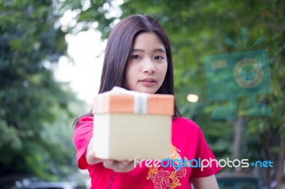 Portrait Of Thai Teen Beautiful Girl In Chinese Dress, Happy New Year And Open Box Gift, Smile And Very Happy Stock Photo