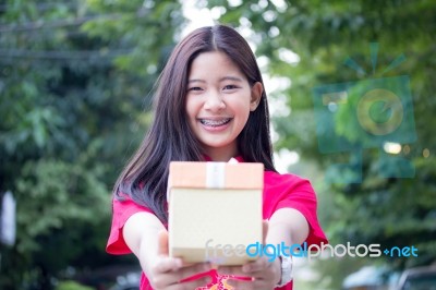 Portrait Of Thai Teen Beautiful Girl In Chinese Dress, Happy New Year And Open Box Gift, Smile And Very Happy Stock Photo