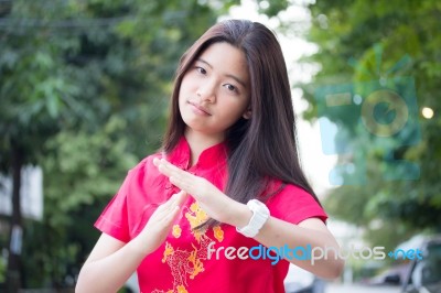 Portrait Of Thai Teen Beautiful Girl In Chinese Dress, Relax And Smile Stock Photo