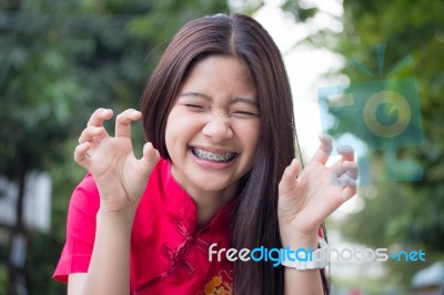 Portrait Of Thai Teen Beautiful Girl In Chinese Dress, Relax And Smile Stock Photo