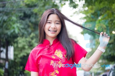 Portrait Of Thai Teen Beautiful Girl In Chinese Dress, Relax And Smile Stock Photo