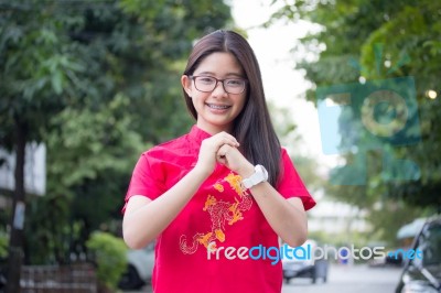 Portrait Of Thai Teen Beautiful Girl In Chinese Dress, Relax And Smile Stock Photo