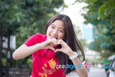 Portrait Of Thai Teen Beautiful Girl In Chinese Dress, Relax And Smile Stock Photo