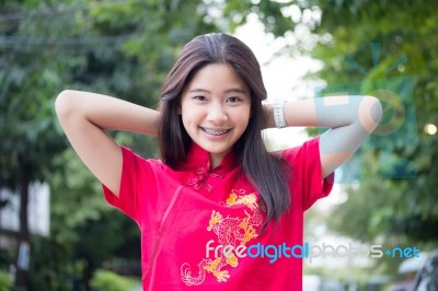 Portrait Of Thai Teen Beautiful Girl In Chinese Dress, Relax And Smile Stock Photo