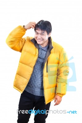 Portrait Of Young Asian Man Wearing Yellow Winter Jacket And Bla… Stock Photo