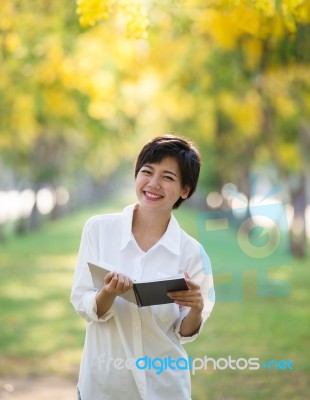 Portrait Of Young Asian Woman And Book In Hand Rising Hand As Victory With Happiness Face Emotion Use For People Success In Education And Business Stock Photo