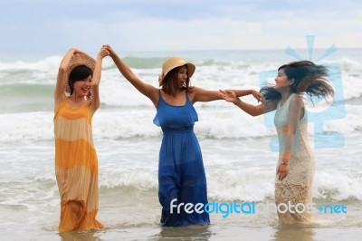 Portrait Of Young Asian Woman With Happiness Emotion Wearing Beautiful Dress Dancing On Sea Beach And Laughing Joyful Use For People Relaxing Vacation On Destination Stock Photo