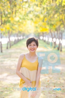 Portrait Of Young Beautiful Asian Woman Wearing Yellow Long Dres… Stock Photo