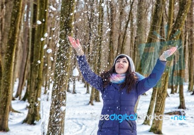 Portrait Of Young Beautiful Woman Playing With Snow In The Woods… Stock Photo