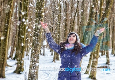 Portrait Of Young Beautiful Woman Playing With Snow In The Woods… Stock Photo