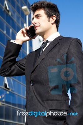 Portrait Of Young Businessman Talking With Smartphone Stock Photo