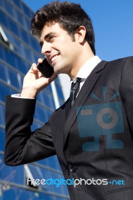 Portrait Of Young Businessman Talking With Smartphone Stock Photo