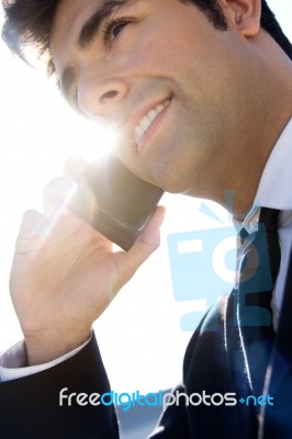 Portrait Of Young Businessman Talking With Smartphone Stock Photo