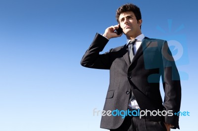 Portrait Of Young Businessman Talking With Smartphone Stock Photo