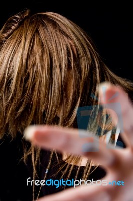 Portrait Of Young Female Hiding Her Face With Hair Stock Photo