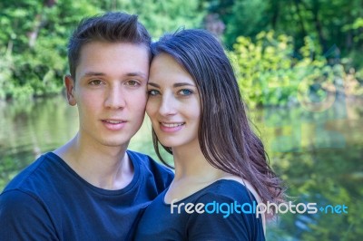 Portrait Young Couple In Love Near Water Stock Photo