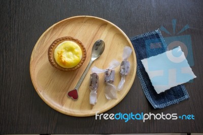 Portuguese Egg Tart On A Wood Dish With White Greeting  Blank Paper Stock Photo