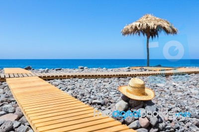 Portuguese Stony Beach With Path Sea Hat And Parasol Stock Photo