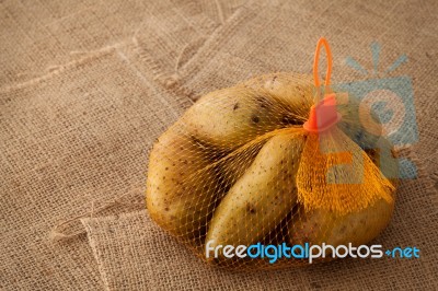 Potato Still Life On Sack Background Stock Photo