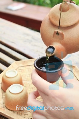 Pouring Chinese Tea On The Cup Stock Photo