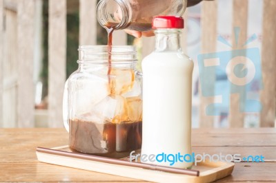 Pouring Espresso To Iced Glass Of Coffee Stock Photo