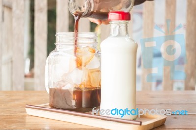 Pouring Espresso To Iced Glass Of Coffee Stock Photo