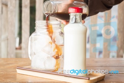 Pouring Espresso To Iced Glass Of Coffee Stock Photo