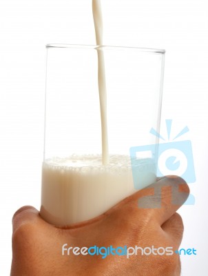 Pouring Milk Into Glass Stock Photo