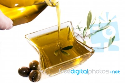 Pouring Olive Oil In Container Stock Photo