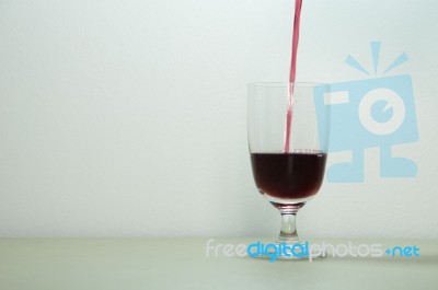 Pouring Red Wine In Glass Stock Photo