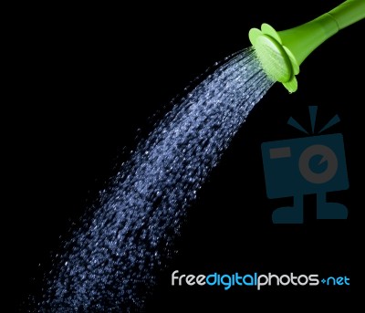 Pouring Water From Green Watering Can Stock Photo