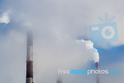 Power Plant Pipes Smoking In The Sky Stock Photo