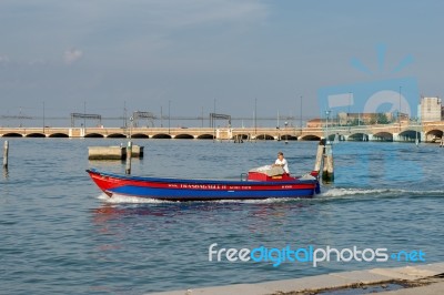 Powerboat Near The Railway Line Into Venice Stock Photo